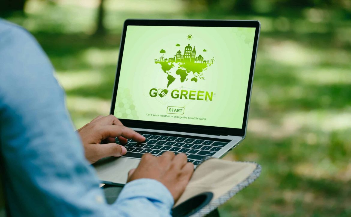 Go Green, Earth Day, Man using a laptop with GO GREEN environment on screen. Green business transformation for modish corporate business for Green energy clean natural energy. World environment day.